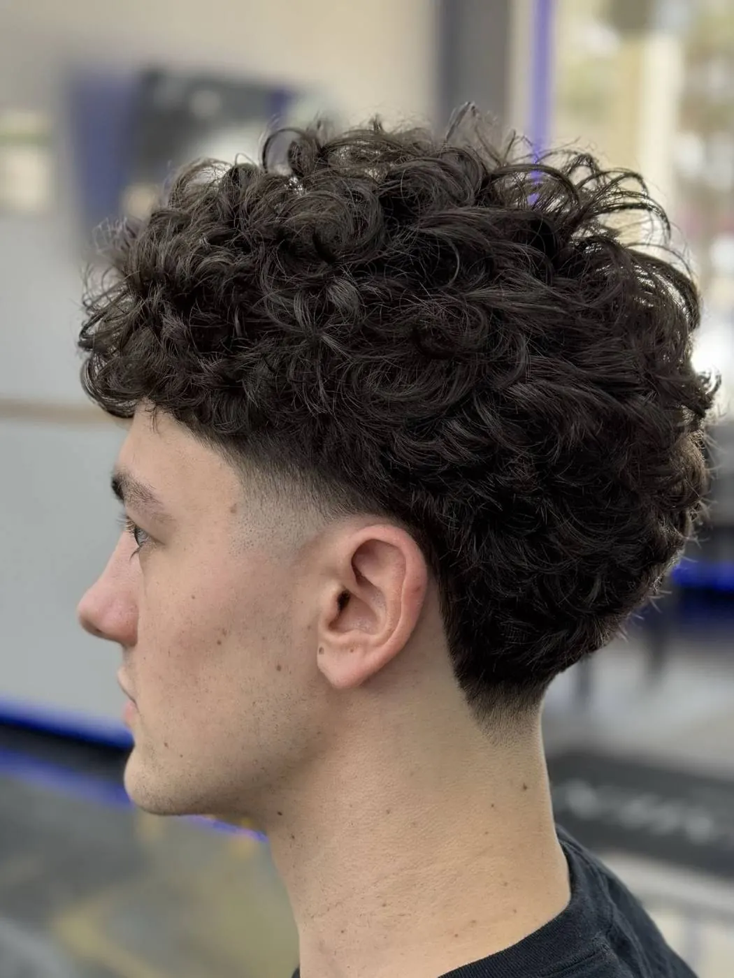 Curly top with a taper fade