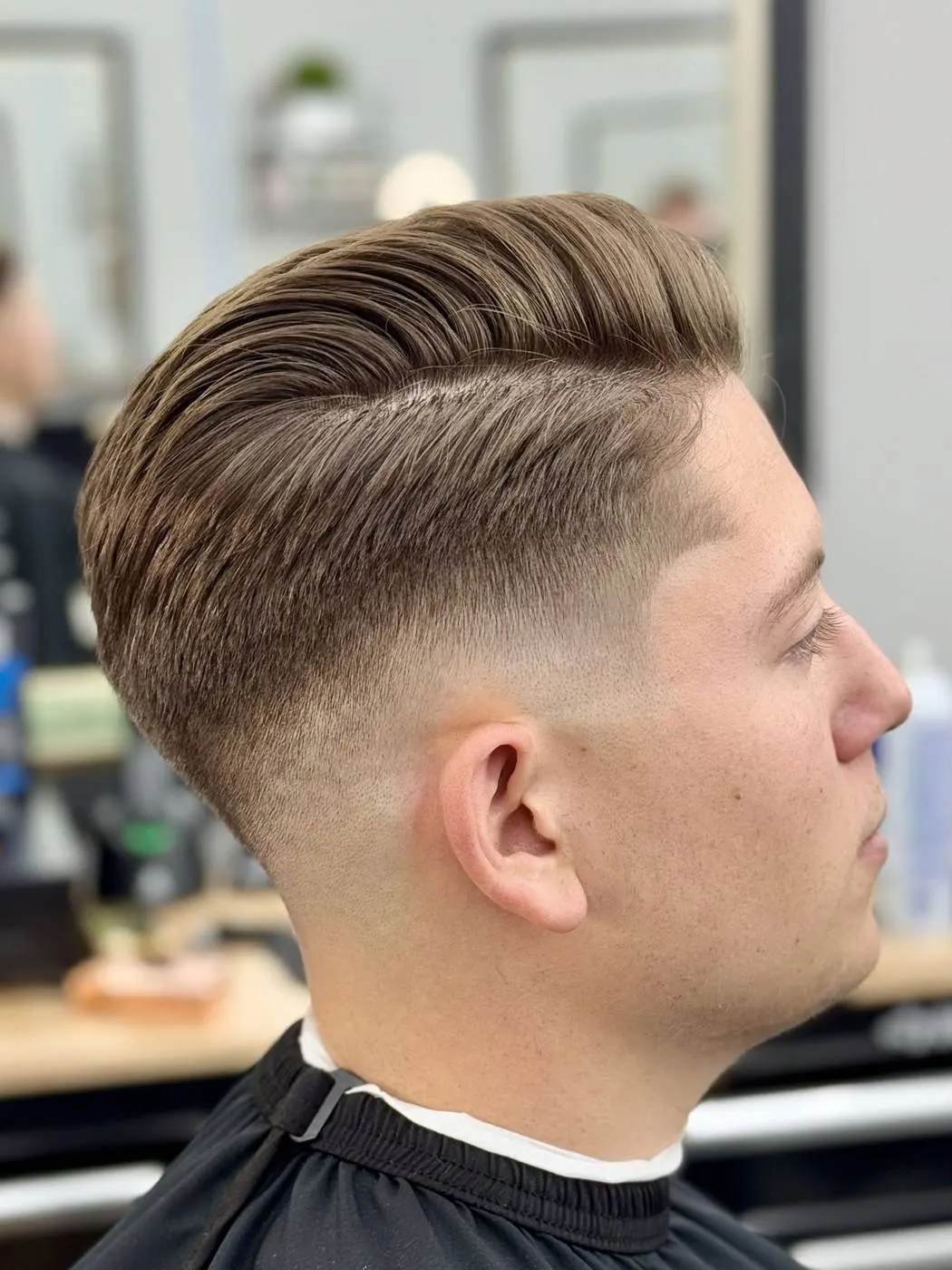 Side-part pompadour with a fade